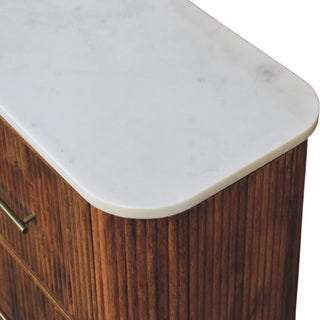 Close-up showing the smooth white marble surface and the textured, vertically panelled wood body.