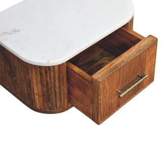 Close-up of the bedside unit with the drawer pulled open, showing the wooden interior and brass handle.