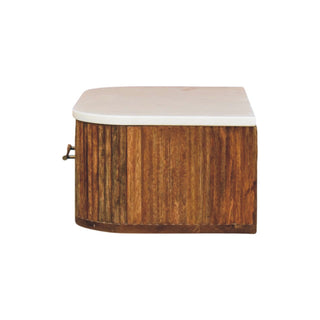 Side profile of the fluted wood bedside unit with white marble top and brass drawer pull.