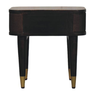 Front view of the dark wood nightstand with woven texture on the curved sides and tapered legs with brass caps.