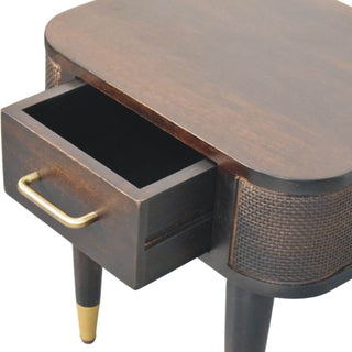 Dark wood bedside table detail showing the open drawer, brass handle, woven side texture, and tapered leg.
