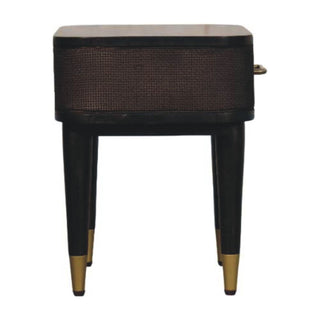 Dark wood bedside table, front view, showing woven texture, curved body, and tapered legs with brass ferrules.