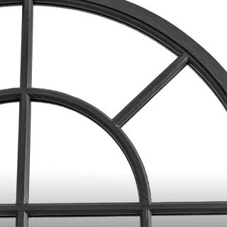 Close detail of the black wood grain texture on the arched mirror frame and window divisions.