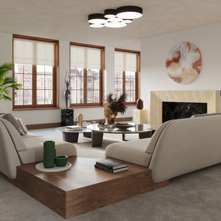 Styled living room with beige sofas, large windows, and a cluster of black and white ceiling lights.