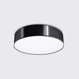 Flush mounted black cylindrical ceiling light, viewed from below showing the white diffuser.