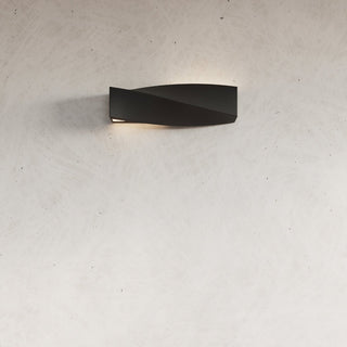 Ceramic SIGMA wall light against a pale, textured plaster wall, showing subtle illumination.
