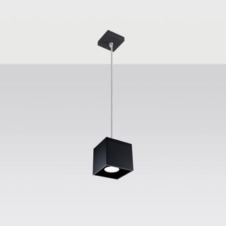 Black cubic pendant light fixture suspended from a square ceiling plate by a thin silver wire.