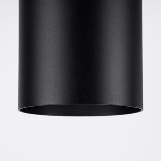 Detail shot of the black cylindrical lamp's bottom opening and fine powder-coated texture.