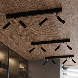 Three black EYETECH ceiling light fixtures installed diagonally on a textured wooden ceiling above a wardrobe.
