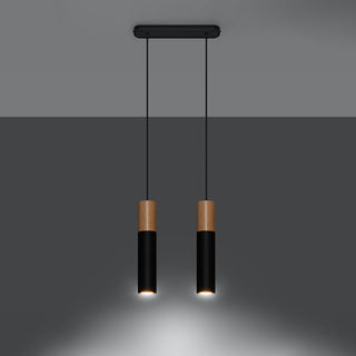 Two black and wood cylindrical pendants illuminated, casting warm downward spotlights.