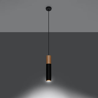 Black and wood cylindrical pendant lamp switched on, showing the focused downward light beam.