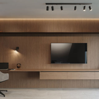 Black ceiling light bar installed above a wood-panelled wall with integrated desk and media unit in a modern room.
