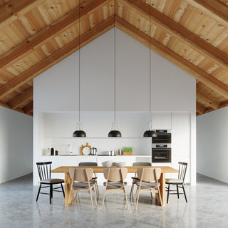 Three CASCO pendant lamps over a dining table in a modern kitchen with a vaulted timber ceiling.