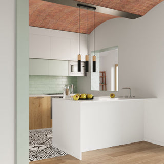 Three black and wood lamps clustered over a white kitchen island beneath an arched ceiling.