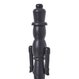 Detail shot of the black wooden nutcracker's head, top hat, and upper body against a white background.