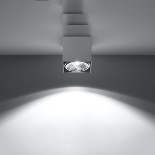 Illuminated white ceiling lamp fixture demonstrating the focused downward light output.