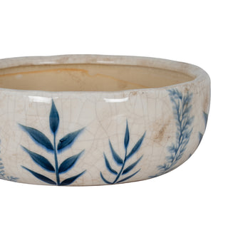 Close view of the bowl's rim and side, highlighting the crazing and blue botanical motif.