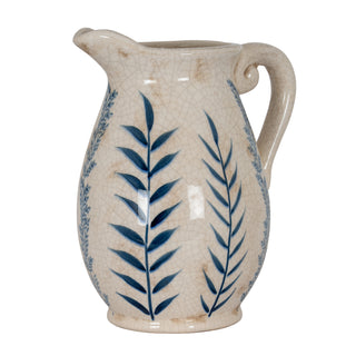 Cream ceramic jug with crackle glaze texture and dark blue leaf pattern, shown front-on.