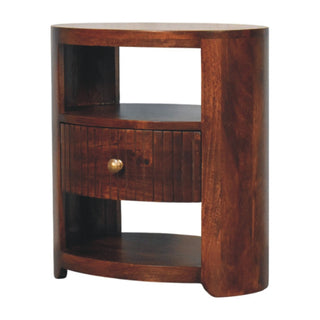 Dark wood bedside table with curved sides, featuring an open top shelf, a fluted drawer, and an open lower shelf.