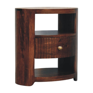 Curved dark wood bedside table featuring a fluted drawer and brass-effect knob.