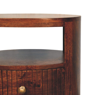 Detail shot of the dark wood grain on the curved side and open shelf area of the Bordeaux bedside.