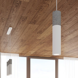 Cylindrical pendant close up showing texture, with the three-light fixture visible against a wooden ceiling.
