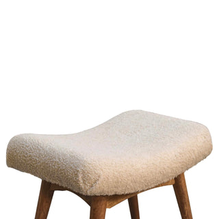 Profile view highlighting the deep, ergonomic curve of the cream boucle bench seat.