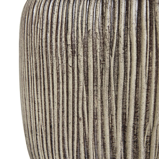 Close-up of the ribbed ochre resin base showing the rough, textured surface.