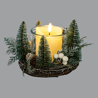 Angled view showing the woven twig base, brush trees, berries, and the central illuminated candle.