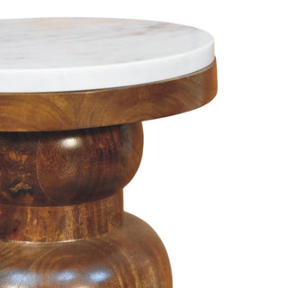 Close-up showing the texture of the white marble top and the polished wooden bulbous base.