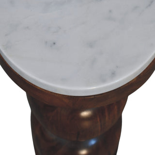 Close-up detail of the rounded edge of the white marble top meeting the polished dark wood base.