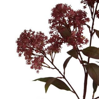 Close detail of the artificial stem showing the clusters of small maroon flowers and dark burgundy leaves.