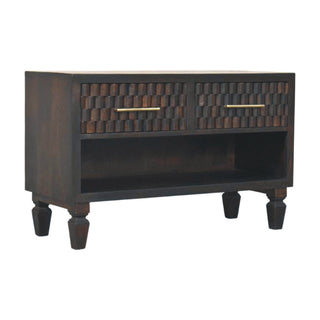 Dark wood bench showing two drawers with geometric block carving, slim brass handles, and lower open storage.