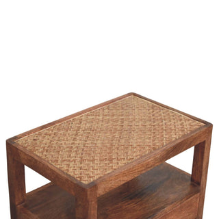 Detail shot of the tight diagonal weave of the natural cane inset on the bedside stand's wooden top.