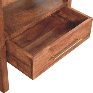 Dark wood bedside stand drawer pulled open, showing the storage depth and slim brass bar handle.