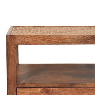 Close-up showing the dark wood frame and the woven cane inset panel on the top surface of the bedside stand.