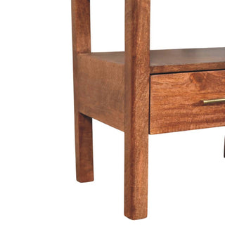 Close-up of the bedside stand's lower legs and rich brown wood grain finish.
