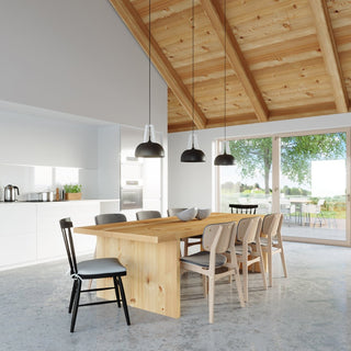 Three CASCO lamps suspended from a vaulted timber ceiling over a wooden dining table.