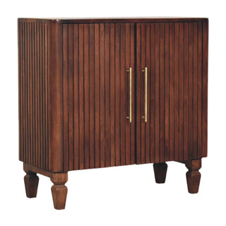 Three quarter view of the dark wood cabinet showing the fluted sides and turned feet.
