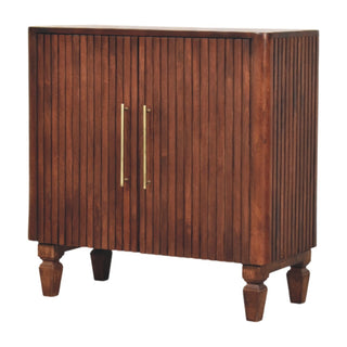 Plain front view of the dark wood cabinet with vertical fluting and long brass handles.