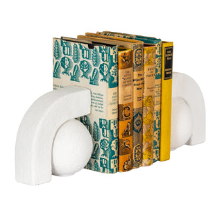 Angled view of the bookends holding several vintage books with patterned spines.