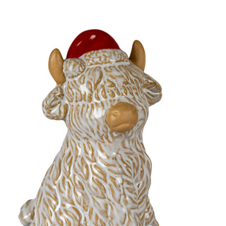 Detail shot of the cow's head and body, showing the raised white glaze simulating shaggy fur.