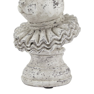 Close view of the distressed ceramic base and pedestal supporting the hare bust.