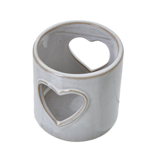 Overhead view of the white ceramic tealight holder showing the top rim and two heart cut-outs.