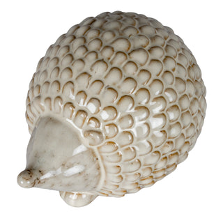 Side view of the ceramic hedgehog showing the detailed, scale-like quill texture and pointed snout.