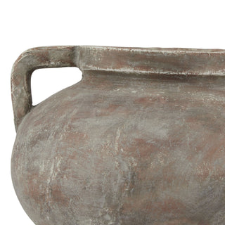 Detail shot of the urn's shoulder showing the rough, patchy texture and contrasting brown and pale grey finish.