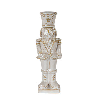 Plain front-on studio shot of the ceramic nutcracker figure in a beige uniform with gold detailing.