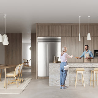 Two white cylindrical ceramic pendant lights suspended over a modern kitchen island bar.