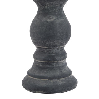 Close detail of the grey ceramic candle holder base, showing the distressed texture and turned column shape.