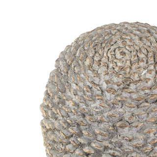 Detail shot of the distressed grey ceramic surface texture with metallic gold accents.